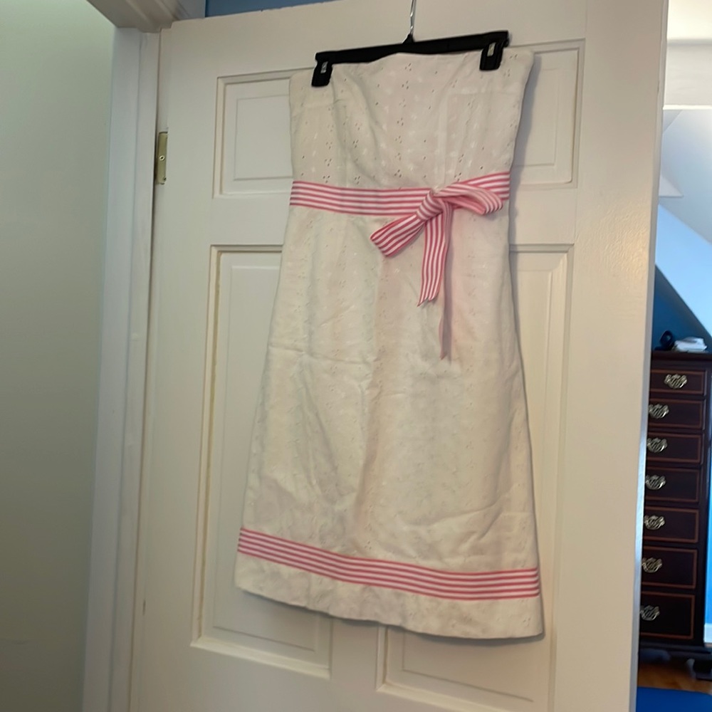 White eyelet dress with pink ribbon. Dress is a size 6